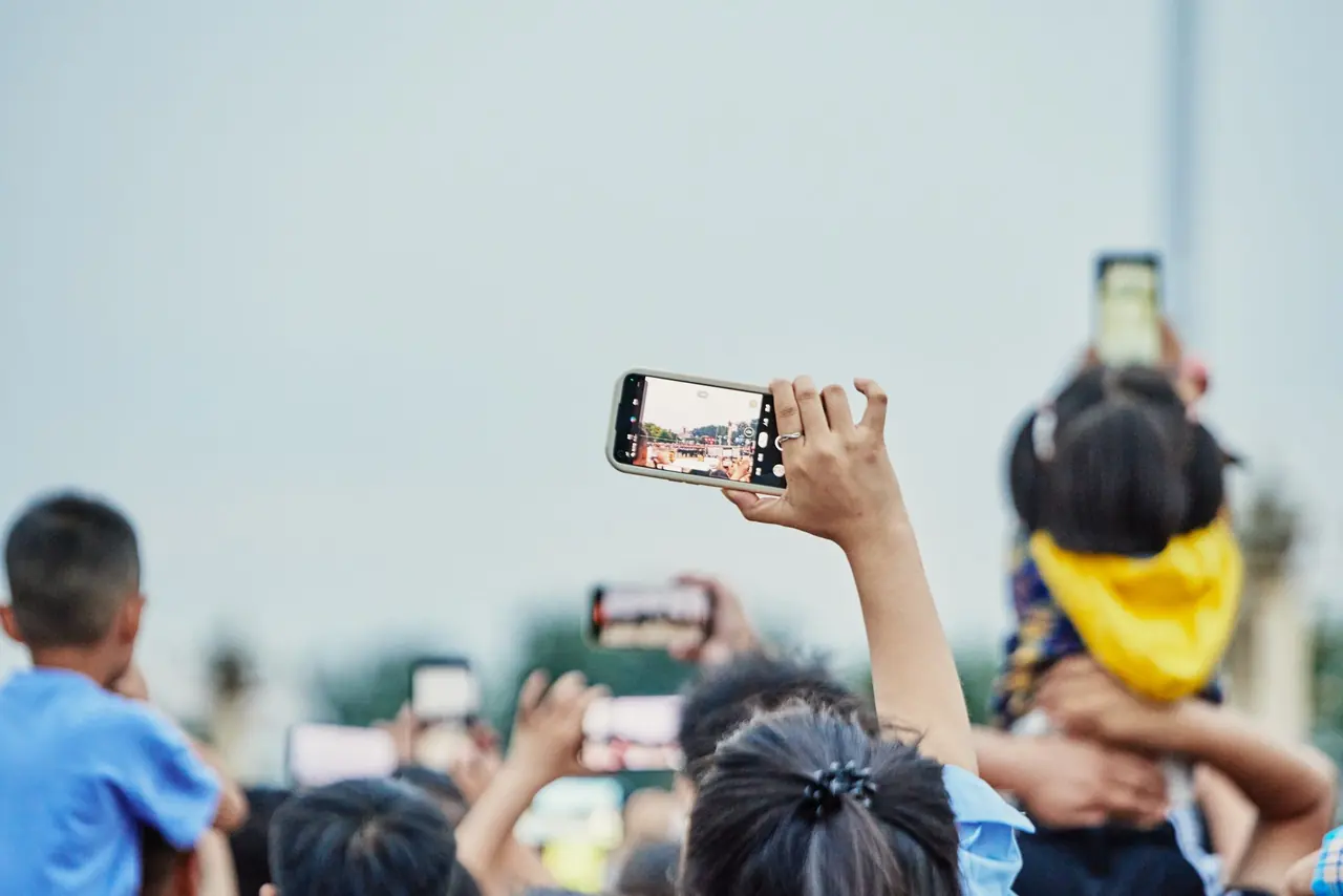 A crowd recording an event on their smartphones